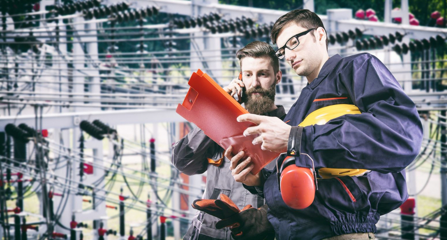 Two engineers looking at a document in a plant