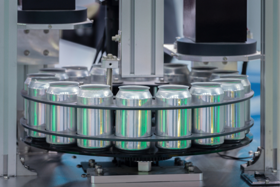 Canned drinks in the processing chain inside a food processing plant