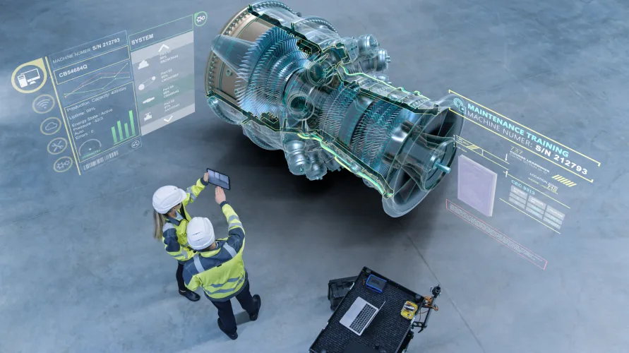 Two engineers in high-visibility jackets viewing a large holographic display of a gas turbine with maintenance and system data panels.