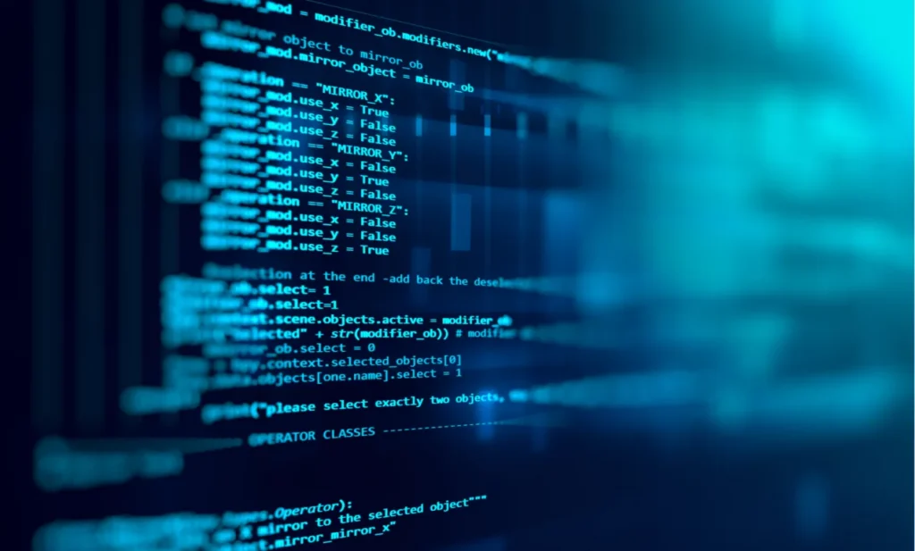 Close-up of programming code on a screen, shown at an angle with a blue glow.