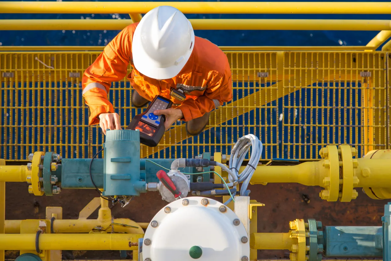 Regulation and Risk Engineer calibrating coriolis digital flow meter
