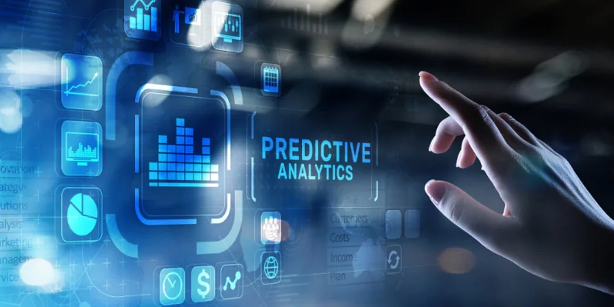 Hand touching a translucent interface panel labelled 'Predictive Analytics', surrounded by charts and data icons.