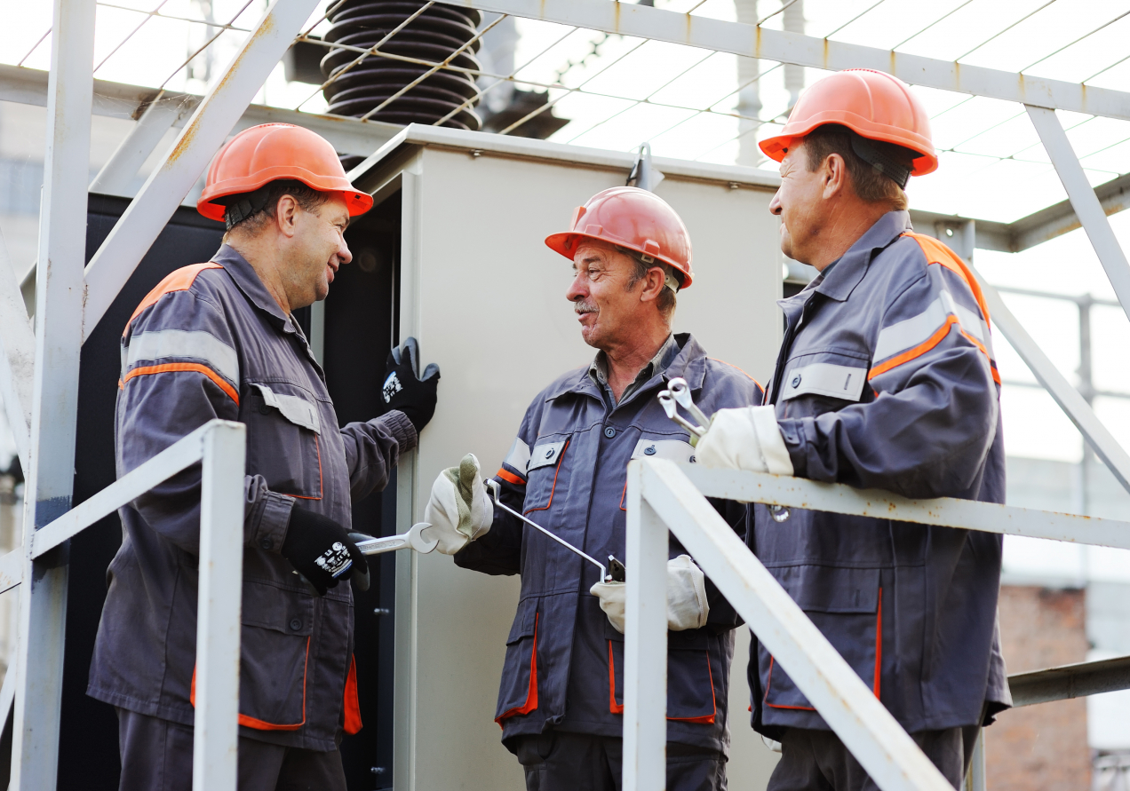 Three engineers talking with each other