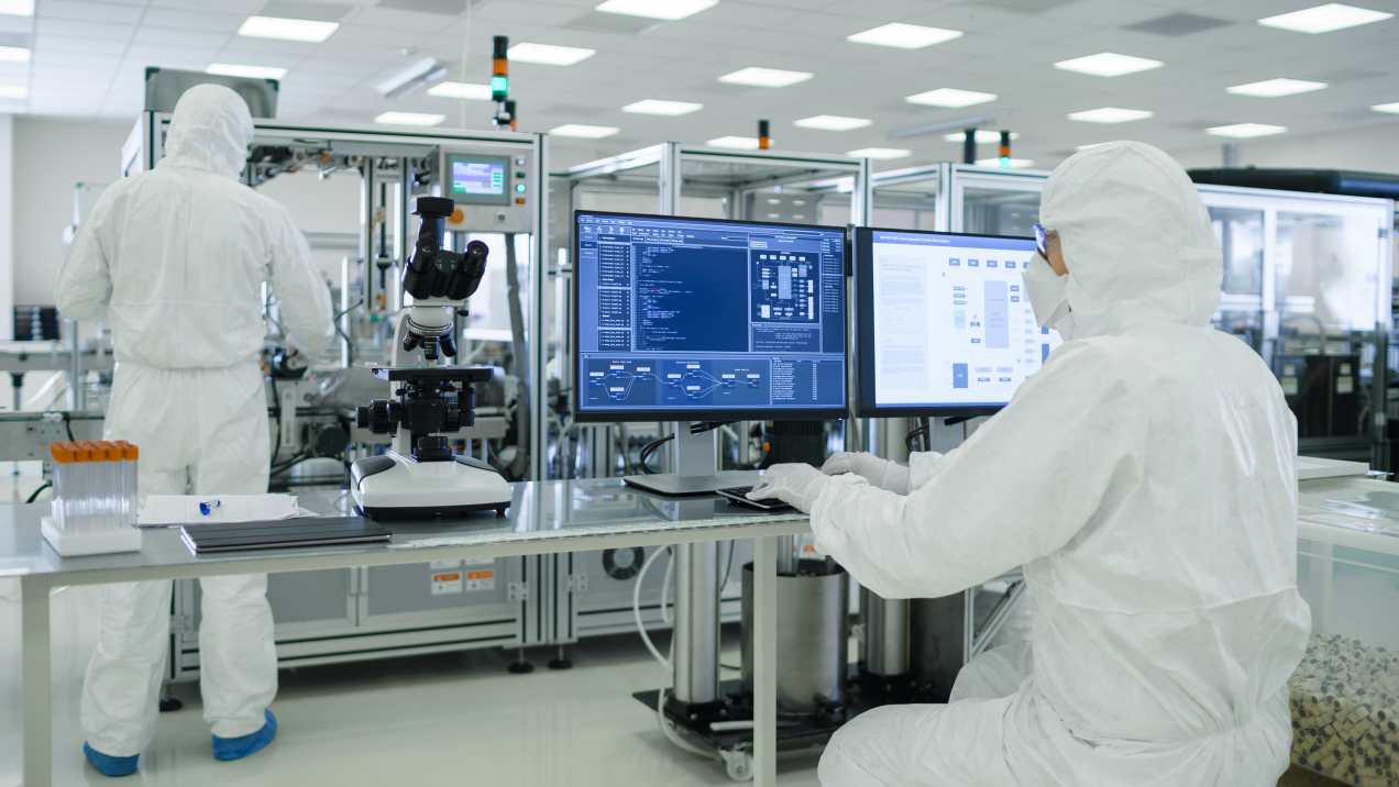 Two workers overseeing a pharmaceutical process