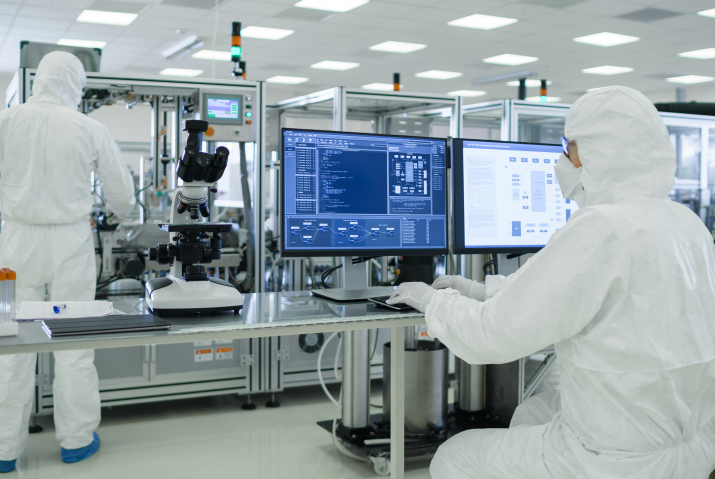 Two workers overseeing a pharmaceutical process