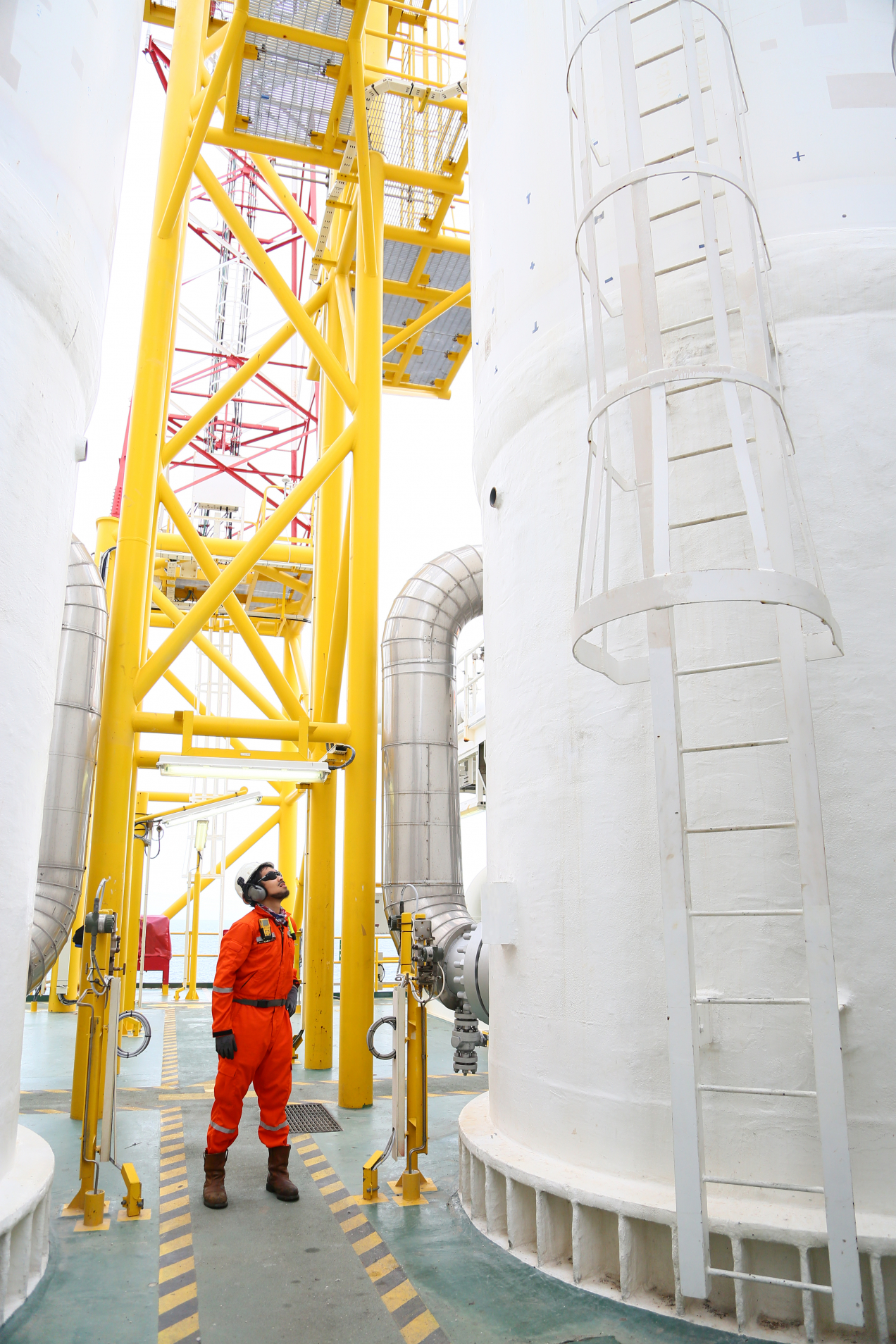 Production Operator standing in the middle of the oil and gas operation plant