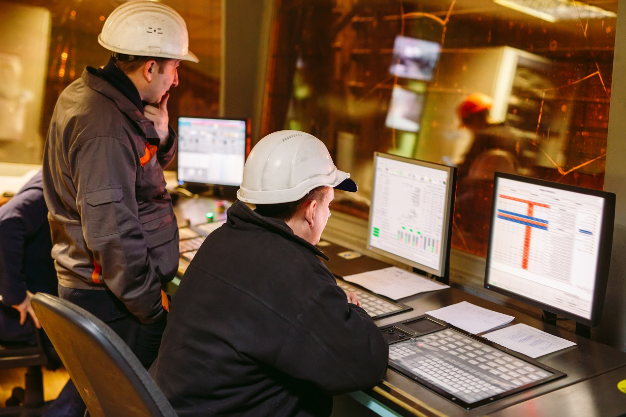 Engineers looking at the control panel