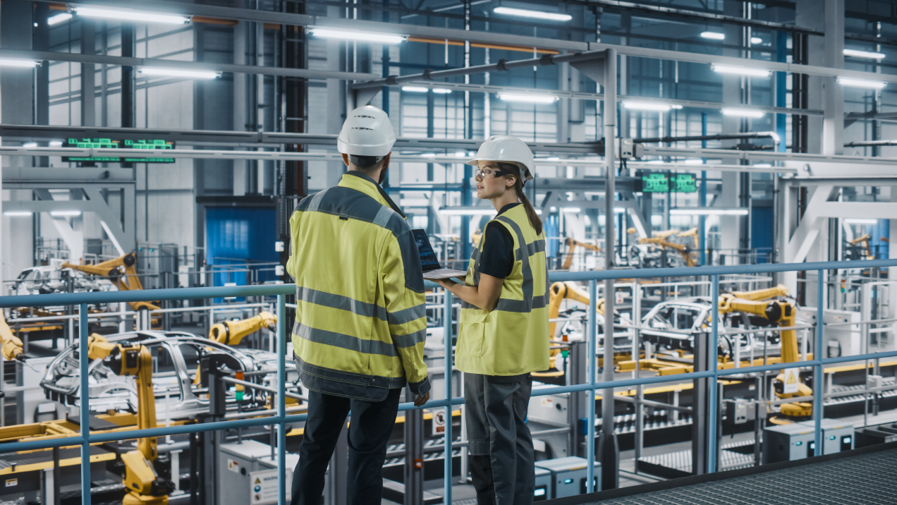 Manufacturing Specialists in Car Factory, Using Laptop Computer